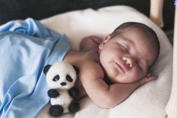 How can I get my newborn to sleep more at night?